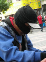 a shoeshine boy in standard garb looks a bit sinister but that's how they are